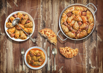 Stuffed Pickled Cabbage Rolls Cooked With Pork Dry Cured Ham And Smoked Ribs Served With Leavened Flatbread On Old Varnished Grunge Cracked Flaky Garden Table