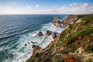 beautiful Atlantic ocean beach with  rocks and waves on horizon. Algarve,  Portugal. top view