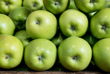 Green apples on a basket