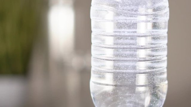 Slow motion. Gas bubbles float in a plastic bottle with drinking water. device for hydrogen rhenium in action. HD
