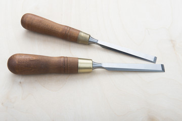 Fototapeta premium Professional chisels on a wooden background