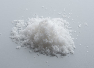 Fototapeta na wymiar Pile of salt on the gray background.