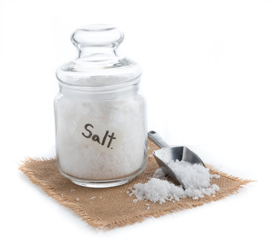 Glass jar with sea salt on table