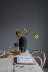 Desk with calender and Teacup and Teapot and a vase of flowers