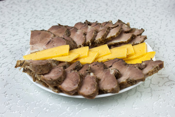 Meat and cheese on a plate.