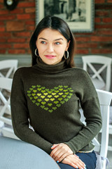 Young beautiful woman in a dark sweater. Concept lifestyle, cafe, fashion.