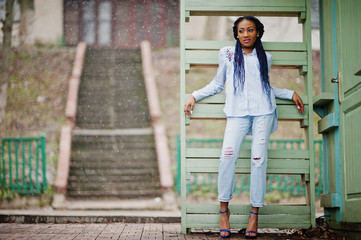 Stylish african american girl with dreads outdoor.