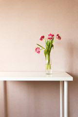 Bouquet of tulips on white table. Work space.