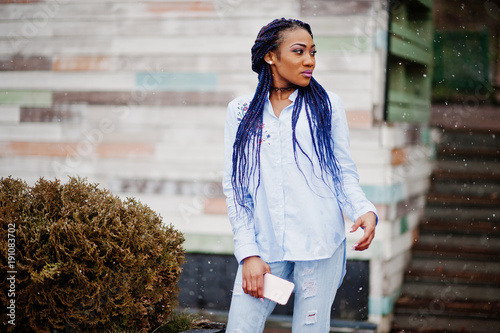 Stylish African American Girl With Dreads Holding Mobile Phone At