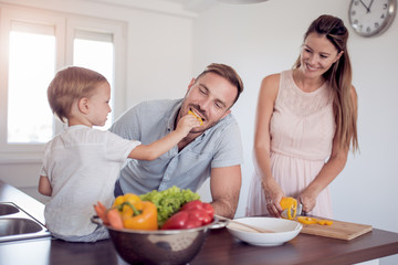 Portrait of a family preparing lunch in the kitchen.