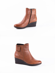 Female brown leather boot on white background, isolated product, comfortable footwear.