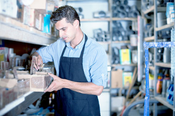 Male is choosing small details in boxes