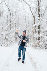 Fototapeta na wymiar man in plaid shirt in the woods in winter