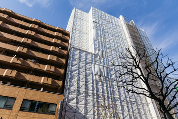 Construction Building facade with covered structure that view from below with sunlight and shadow...