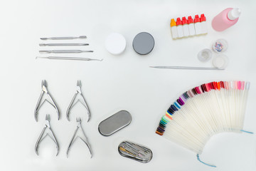 Set for manicure. Tools, nail file, palette, care products. White background.