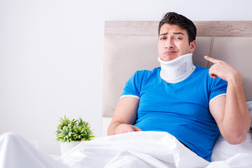 Young man with neck injury in the bed