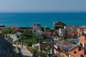 Fototapeta na wymiar Top view on the resort city of Sudak on a Sunny day. Crimea, the concept of summer vacation