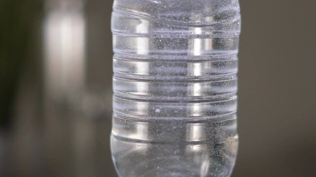 Slow motion. Gas bubbles float in a plastic bottle with drinking water. device for hydrogen rhenium in action. HD
