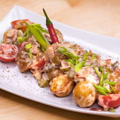Roasted potatoes with vegetables and mushrooms