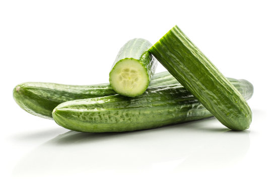 European cucumbers (burpless, seedless, hothouse, gourmet, greenhouse or English) set isolated on white background two whole and two fresh cut halves.