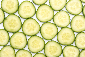 European cucumber slices background top view (burpless, seedless, hothouse, gourmet, greenhouse, English) isolated on white.