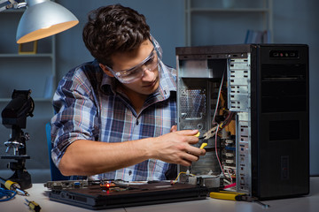 Man repairing computer desktop with pliers