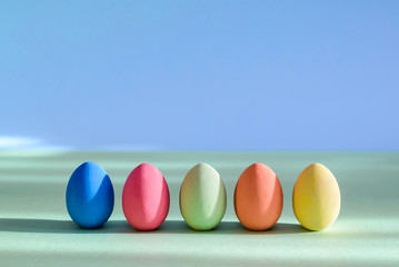 Colorful Easter eggs are standing in a row