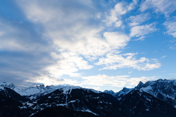 Obraz premium blue sky with clouds over dark mountain tops