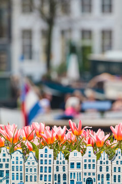 Tulips and souvenir canal houses in front of an Amsterdam canal