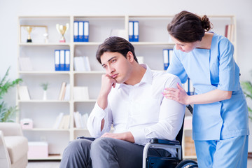 Obraz premium Disabled patient on wheelchair visiting doctor for regular check