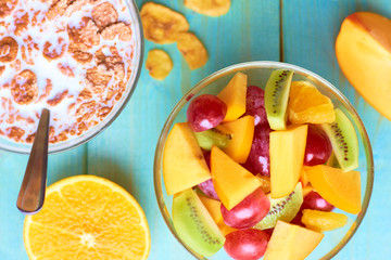 Fresh fruit salad and cereals with milk. Delicious diet breakfast.