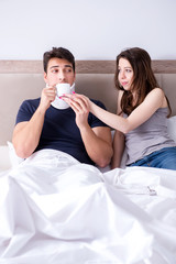 Loving wife taking care of injured husband in bed