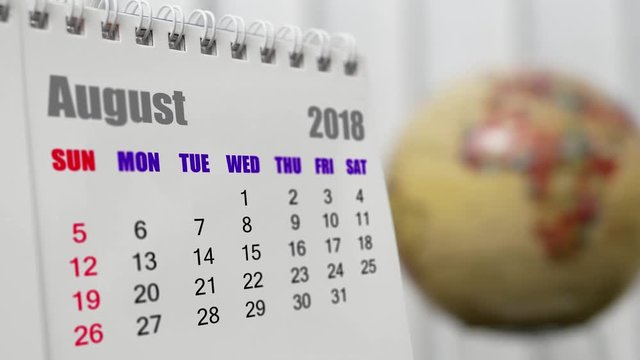 Motion of August 2018 calendar with blur earth globe turning background
