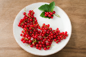 Fresh ripe organic red currant in plate.
