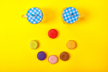 Colorful sweet macaroons and a cup of tea.Sweet smile.