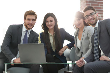 Business people are using a laptop during the conference in offi