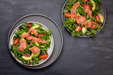 Fresh salad made of salmon, tomatoes and avocado