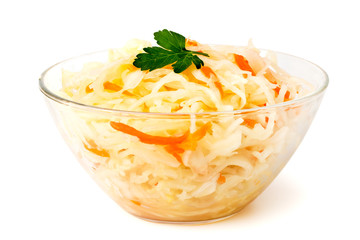 Sauerkraut with carrots and a sprig of parsley in a glass dish.