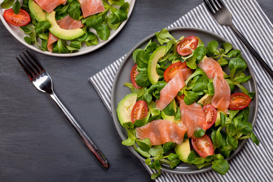 Fresh salad made of salmon, tomatoes and avocado