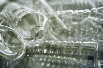 Line for the production of plastic PET bottles on the background of the worker. Preparation of containers for drinks and sunflower oil