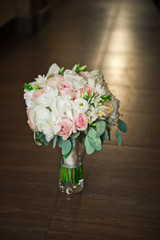 Beautiful bouquet of roses in a vase on the varnished floor 526.