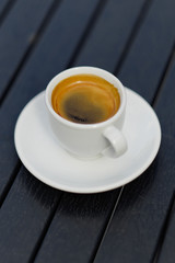 White coffee cup on black wood table background