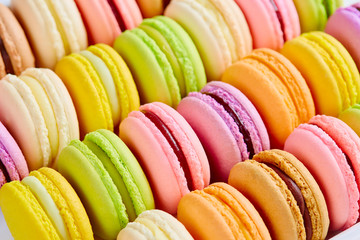 French colorful macarons background, close up.