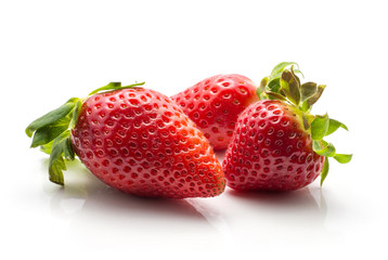 Three garden strawberries isolated on white background ripe and fresh.