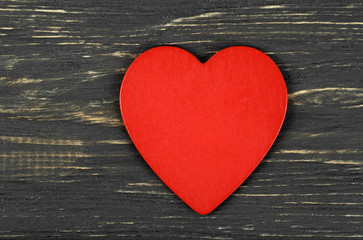 Red heart on wooden background. Background in style of Valentine's Day.