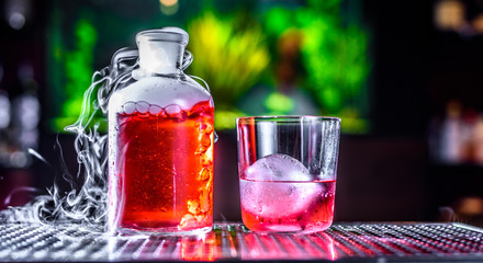 Cranberry drink with ice, on dark background