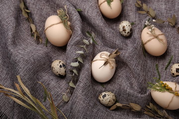 Chicken and quails eggs with decorative elements on black background