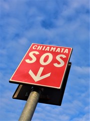 Cartel llamada de zocorro, con el fondo azul blanco del cielo