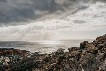 View of the town Palm Mar and the ocean with the rock on the front in the evening
