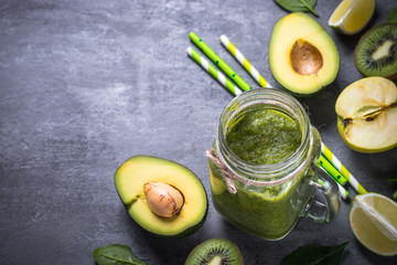 Healthy green smoothie in mason jar and ingredients. 